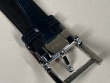 a black belt with a silver buckle on a white surface