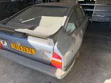a car that is parked in a garage with the door open
