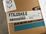a box with a sticker on it sitting on the floor