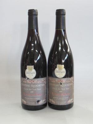 two bottles of wine sitting on top of a table next to each other