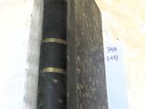 an old book on a table with a note on it