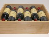 six bottles of wine in a wooden box