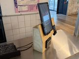 a laptop sitting on top of a counter in a restaurant