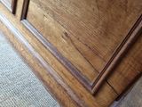 a close up view of a wooden cabinet with a door