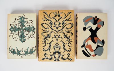 three wooden blocks with different designs on them on a white surface