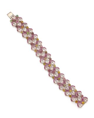 a close up of a bracelet with pink beads on a white background