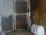 a white van that has a bunch of bags in the back