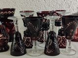 many wine glasses and vases on the table
