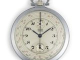 une montre de poche en argent avec un cadran blanc sur fond blanc