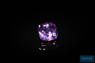 des pierres précieuses améthorates violettes sur une surface noire