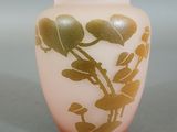 a glass vase with a gold leaf design on it
