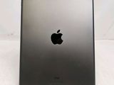 the back of an ipad with a black apple logo on it