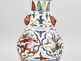 a white vase with a blue and red design on it