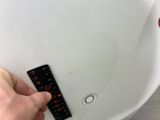 a person holding a remote control in their hand