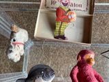 a glass display case with toys and a book on the table