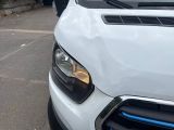 a white car parked in a parking lot next to a building