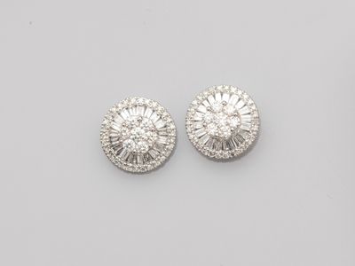 a pair of diamond and white gold earrings