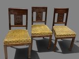 three wooden chairs with upholstered seats and a yellow seat pad