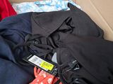 a box full of clothes and a cell phone in it