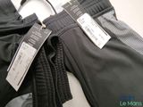 two pairs of pants with tags on them on a table