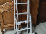 a ladder that is sitting next to a bed