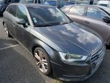a black audi parked in a parking lot with other cars in the background