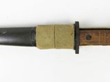 an old knife with a wooden handle on a white surface