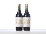 two bottles of wine sitting on top of a table