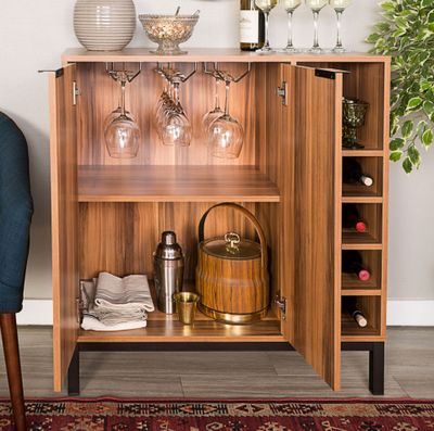 a wooden cabinet with wine glasses on top of it