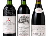 three bottles of wine are lined up on a white surface