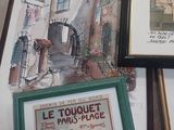 three framed pictures on a table with pictures on it