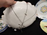a person that is holding a white bowl with a wire around it
