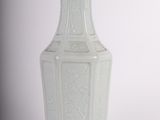 a white vase that is sitting on a table