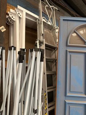 many ladders that are leaning against a door