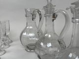 bottles and glasses are lined up on a table with a white background