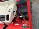 a red and white tractor with a light on it