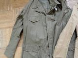 a jacket and a jacket sitting on the floor next to each other
