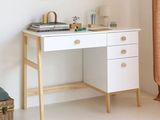 a white desk with a mirror above it in a room