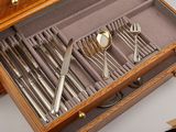a wooden box with silverware in it on a table