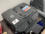 a suitcase sitting on top of a table next to a chair