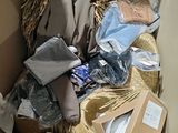 a cardboard box filled with clothes and other items