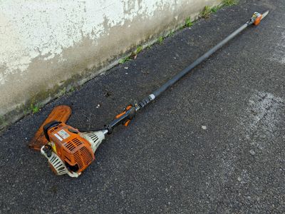 an image of a lawn mower laying on the ground