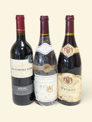 trois bouteilles de vin sont alignées sur une surface blanche