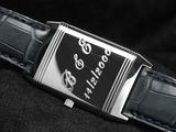 a close up of a watch on a black cloth