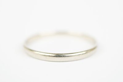 a close up of a silver ring on a white surface