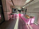 a pink counter in the middle of a restaurant