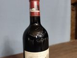 a bottle of wine sitting on a wooden table