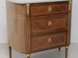 a marble top chest of drawers in a room