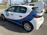 a white car with a blue and red stripe parked in a parking lot