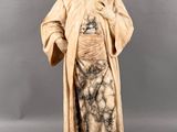 statue of a man with a long beard wearing a robe and a robe